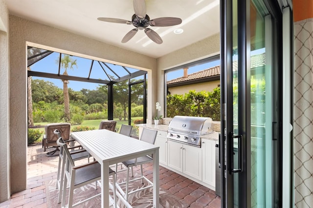 sunroom featuring ceiling fan