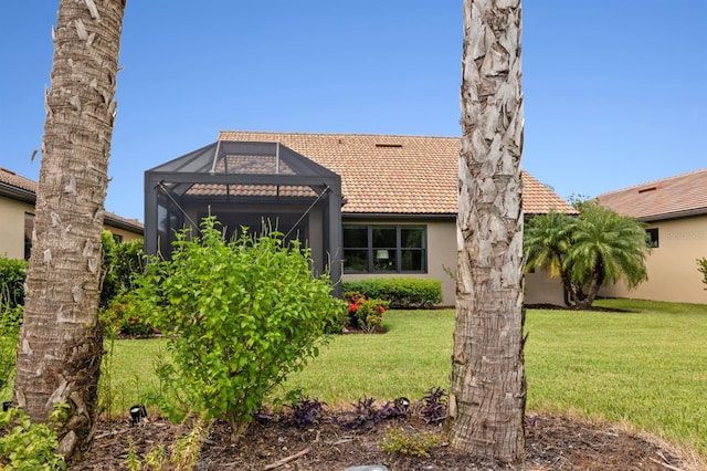 view of front of property with a front lawn and a lanai