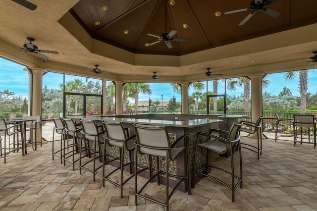 view of patio / terrace with a bar and ceiling fan