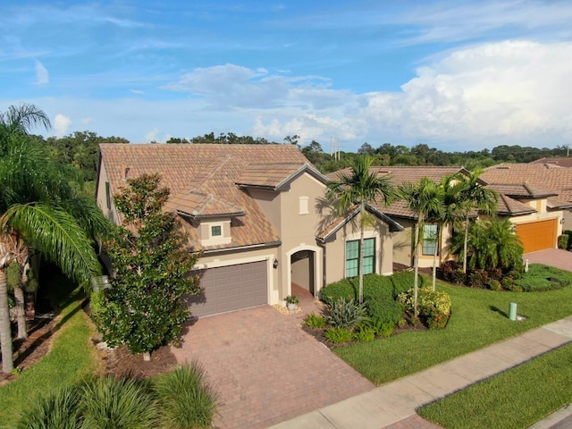 mediterranean / spanish house featuring a front lawn