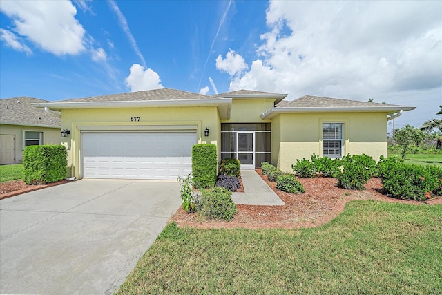 view of front of property featuring a garage and a front lawn