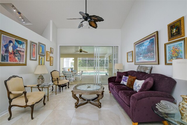 living room featuring rail lighting, ceiling fan, and light tile patterned flooring