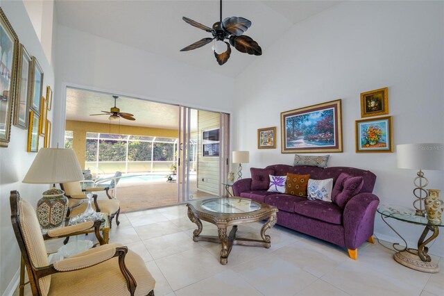 tiled living room with lofted ceiling and ceiling fan