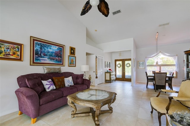 tiled living room featuring high vaulted ceiling, ceiling fan, and french doors