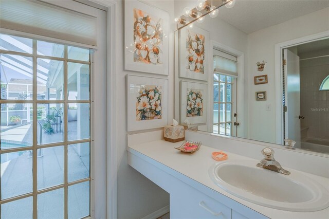 bathroom featuring a textured ceiling and vanity