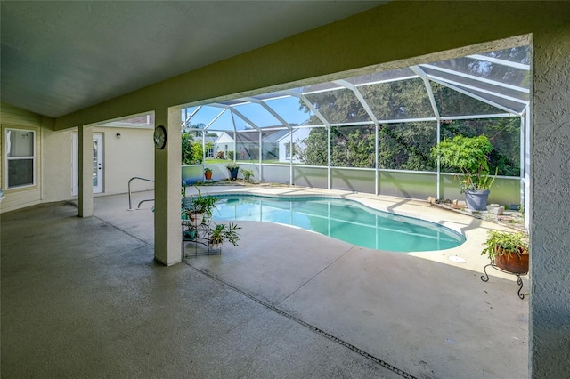 view of pool featuring glass enclosure and a patio