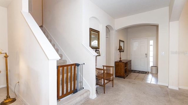 entryway featuring light carpet and a wealth of natural light