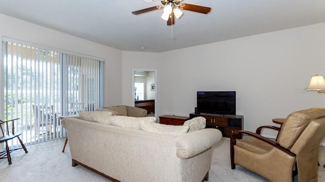 living room with light carpet and ceiling fan