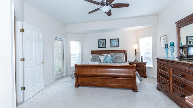 bedroom with ceiling fan and light colored carpet