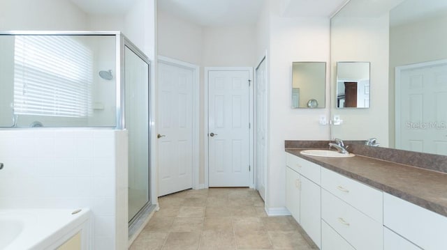 bathroom featuring independent shower and bath and vanity