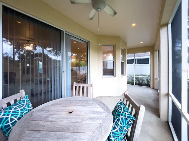 sunroom featuring ceiling fan