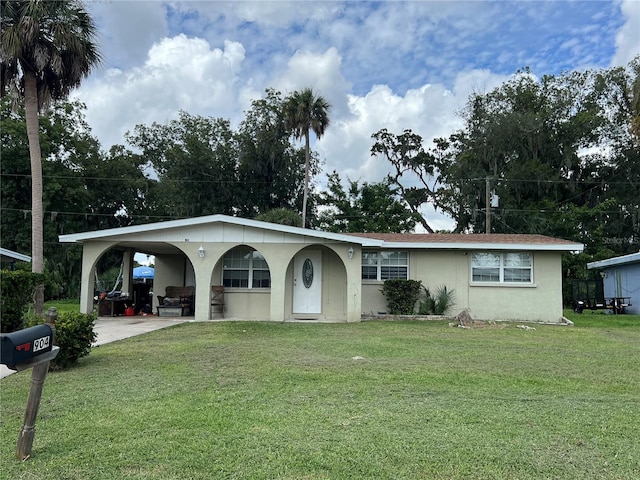 ranch-style house with a front lawn and a carport