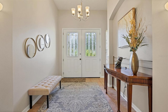 foyer featuring an inviting chandelier and light tile patterned flooring