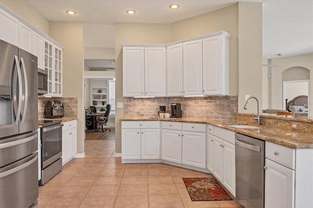 kitchen featuring appliances with stainless steel finishes, white cabinetry, and light tile patterned floors