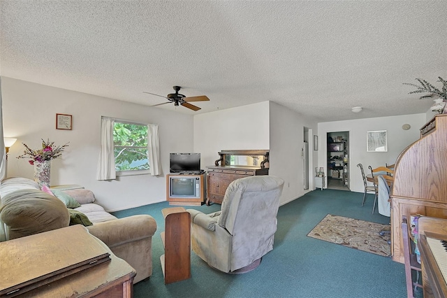 carpeted living room with ceiling fan and a textured ceiling