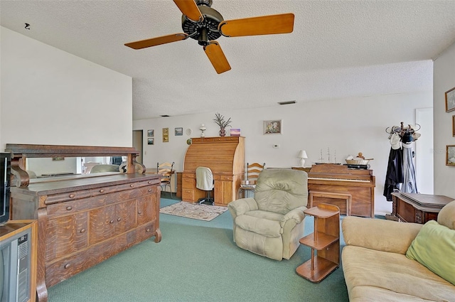 carpeted living room featuring ceiling fan and a textured ceiling