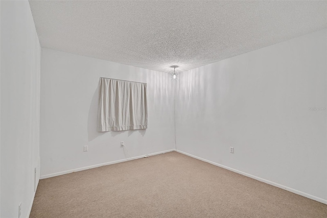 carpeted spare room featuring a textured ceiling