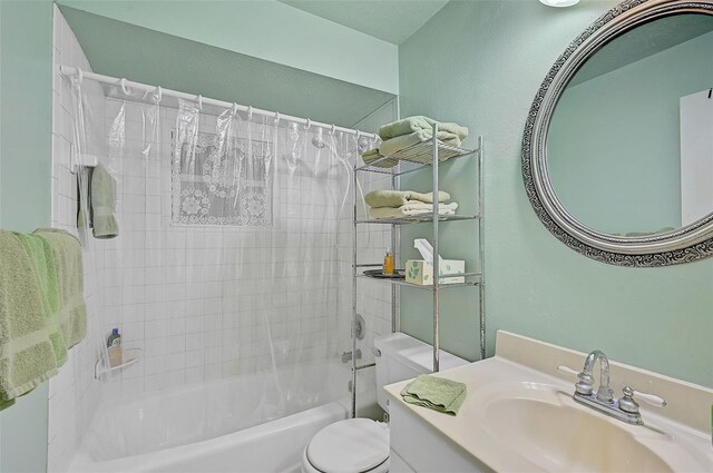 full bathroom with shower / bath combination with curtain, vanity, and toilet