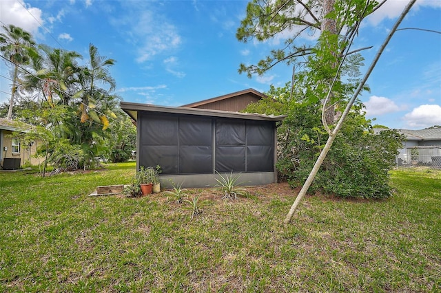 garage featuring central AC unit and a yard