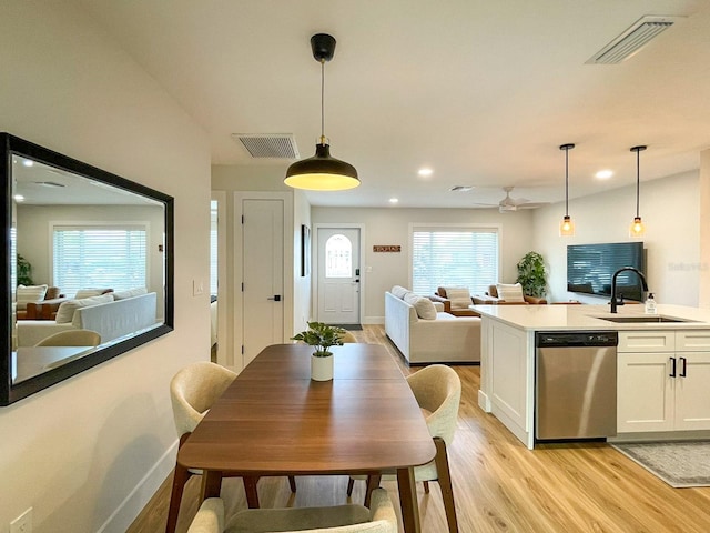 dining area featuring light hardwood / wood-style flooring and sink