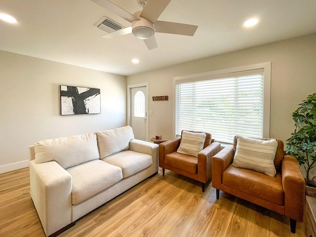 living room featuring ceiling fan and light wood-type flooring