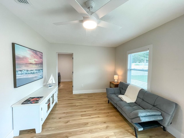 living room with light hardwood / wood-style flooring and ceiling fan