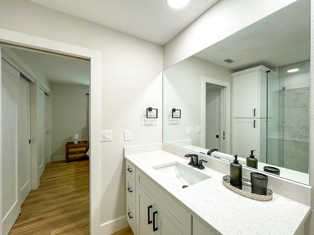 bathroom featuring vanity, a textured ceiling, and hardwood / wood-style floors