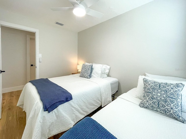 bedroom featuring ceiling fan and hardwood / wood-style flooring