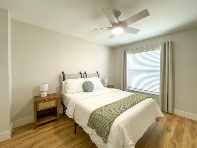 bedroom with light wood-type flooring and ceiling fan