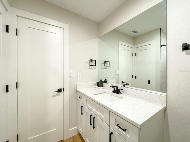 bathroom featuring vanity and wood-type flooring