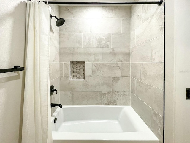 bathroom with shower / bathtub combination with curtain