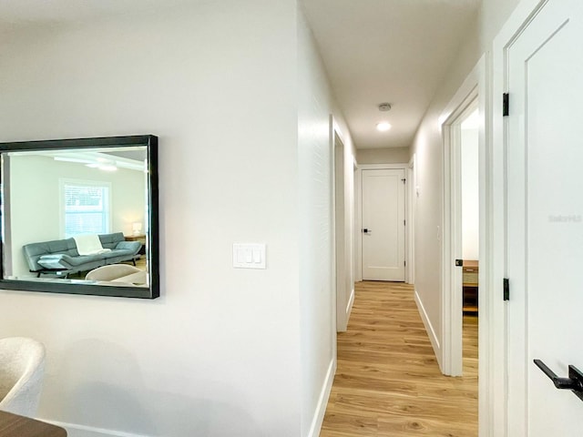 corridor with light wood-type flooring