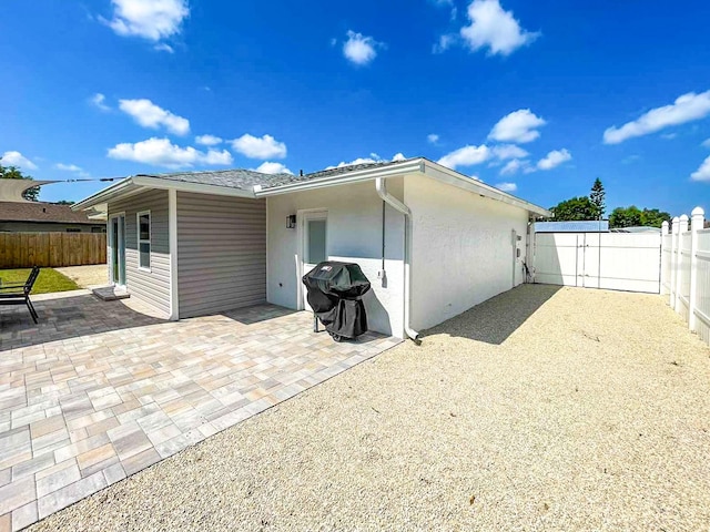 back of property with a patio