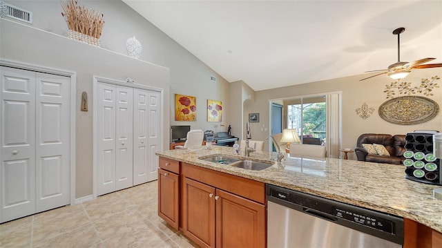 kitchen with ceiling fan, light stone counters, sink, and stainless steel dishwasher