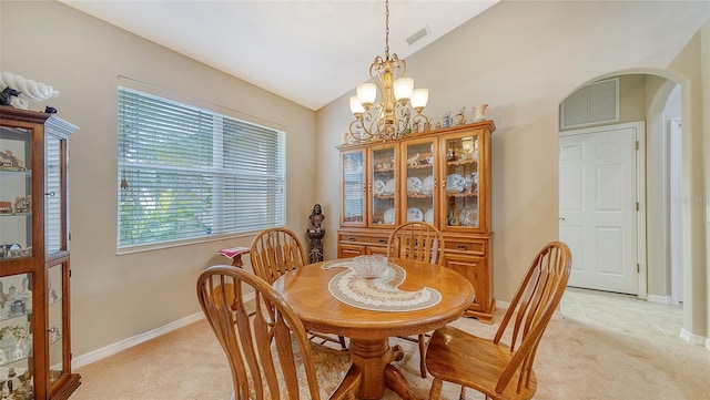 carpeted dining room with lofted ceiling and a notable chandelier