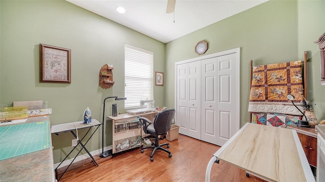 office with ceiling fan and light hardwood / wood-style floors