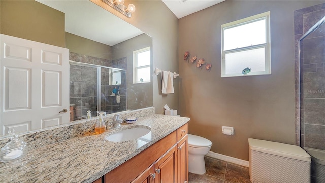 bathroom featuring vanity, toilet, an enclosed shower, and tile patterned flooring