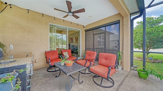 sunroom featuring ceiling fan