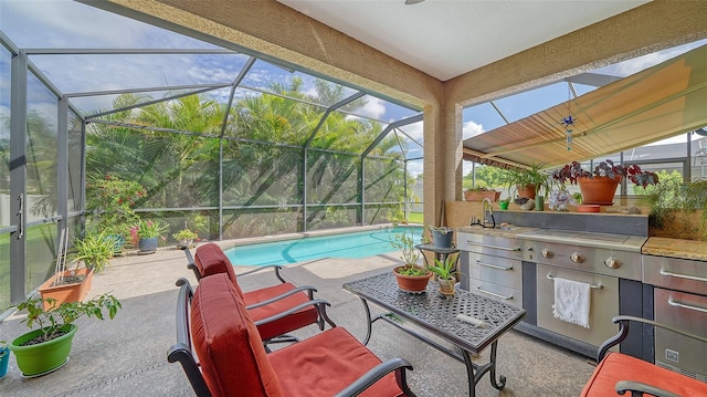 view of patio / terrace featuring glass enclosure and sink