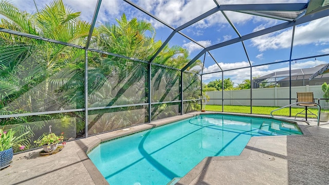 view of pool featuring glass enclosure and a patio