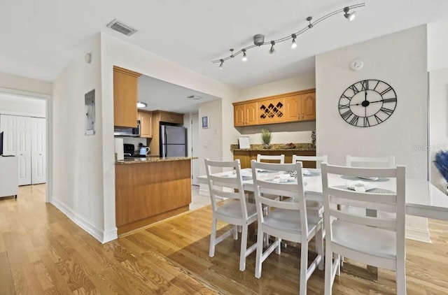 dining area featuring light wood-type flooring