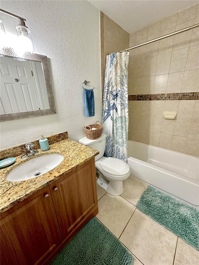 full bathroom with vanity, toilet, shower / bath combo with shower curtain, and tile patterned floors