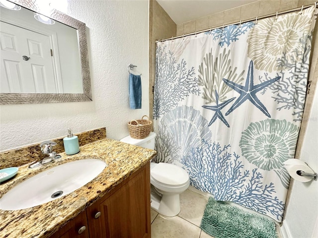 bathroom with curtained shower, vanity, toilet, and tile patterned floors