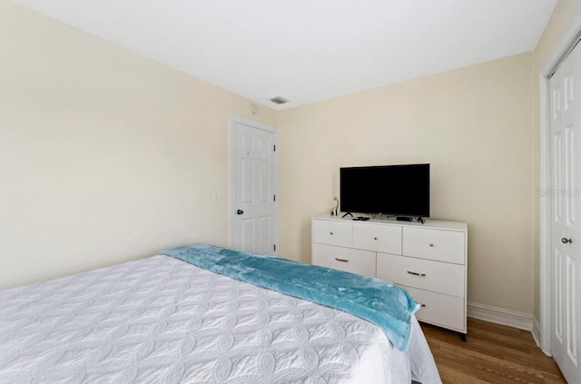 bedroom with a closet and light hardwood / wood-style floors