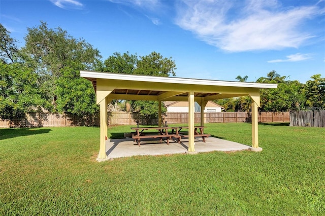 surrounding community with a yard and a patio