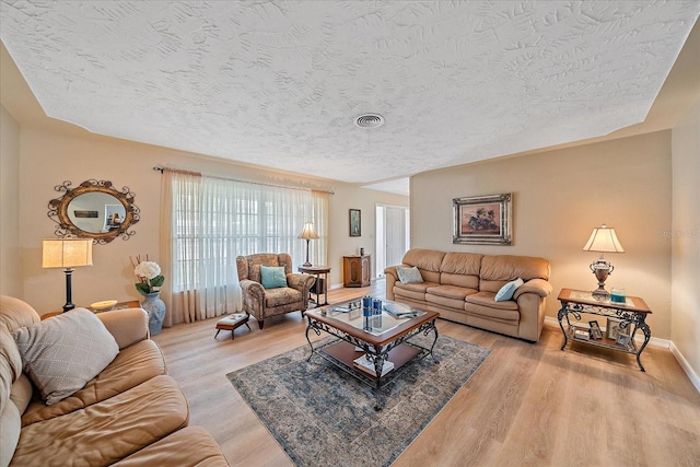 living room featuring a textured ceiling and hardwood / wood-style flooring