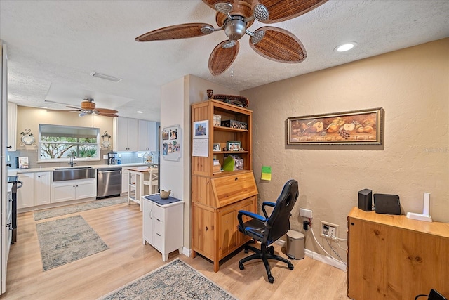 office with ceiling fan, a textured ceiling, light wood-type flooring, and sink