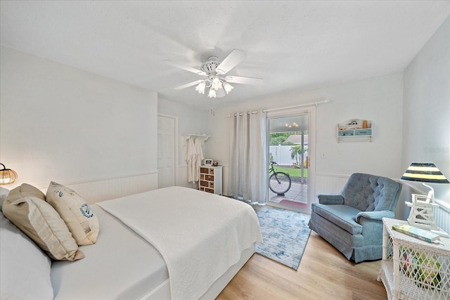 bedroom featuring light hardwood / wood-style floors, ceiling fan, and access to outside