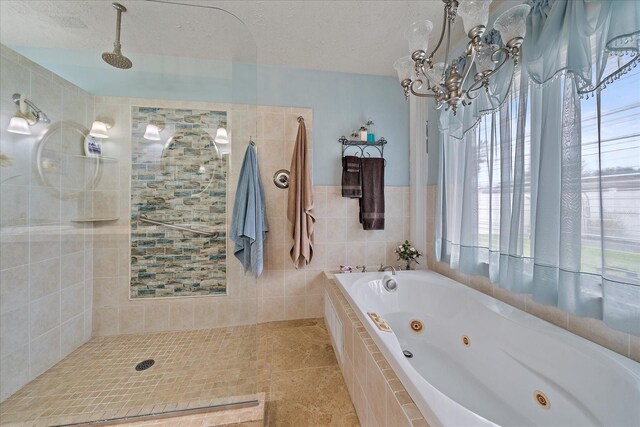 bathroom with independent shower and bath, a textured ceiling, tile patterned floors, a notable chandelier, and tile walls