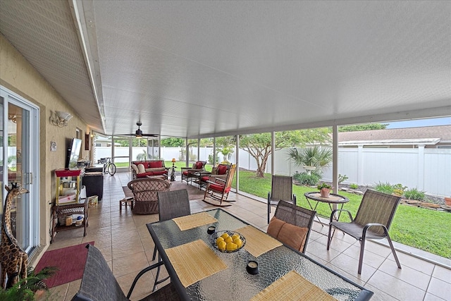 sunroom with ceiling fan and a healthy amount of sunlight